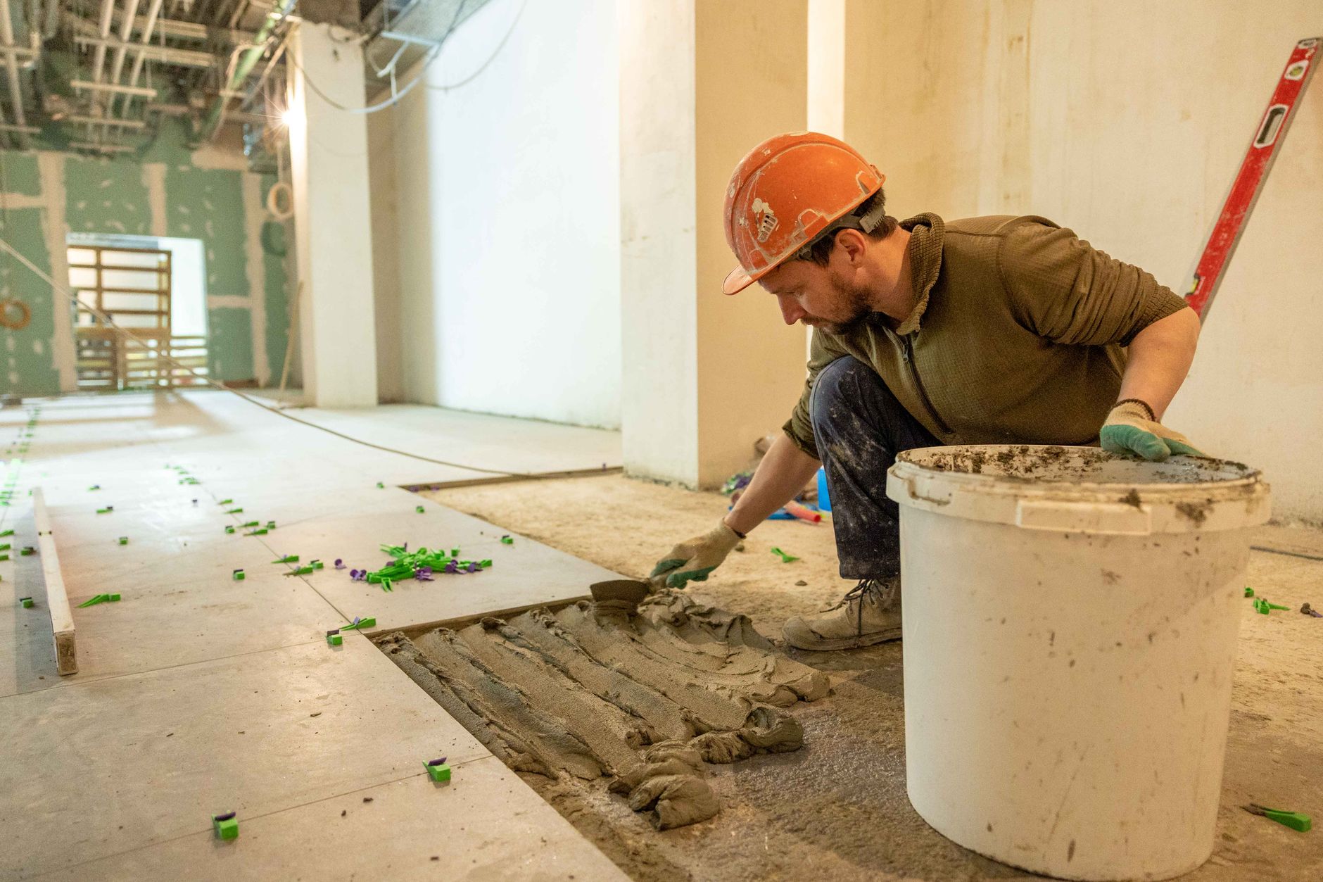 Construction worker installing flooring